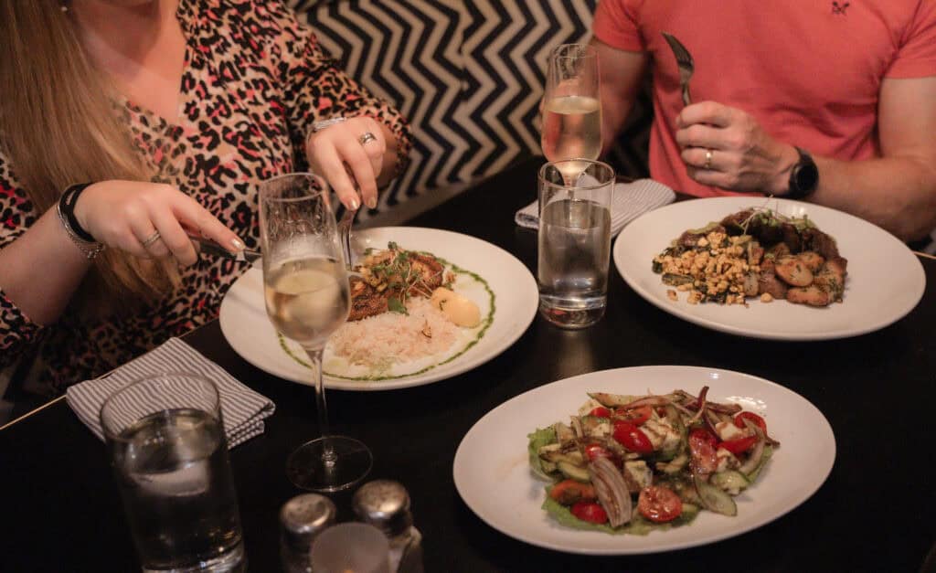 Elegant table setting with Mediterranean dishes at Saltwater Grill, Grand Cayman, showcasing vibrant culinary presentation