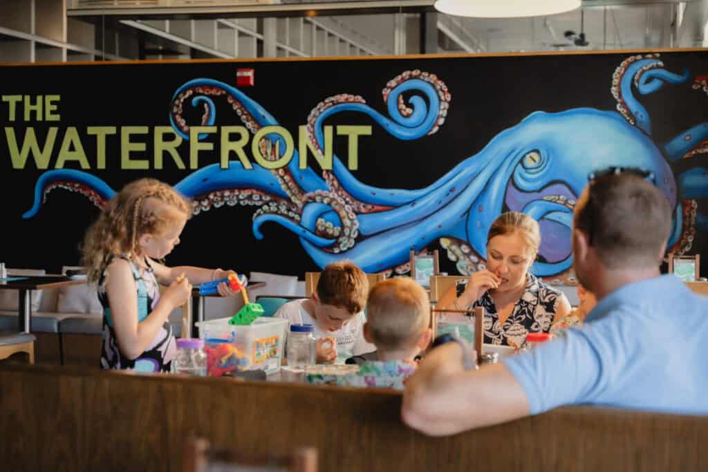 A family enjoying a meal at a family friendly restaurant in the Cayman Islands.